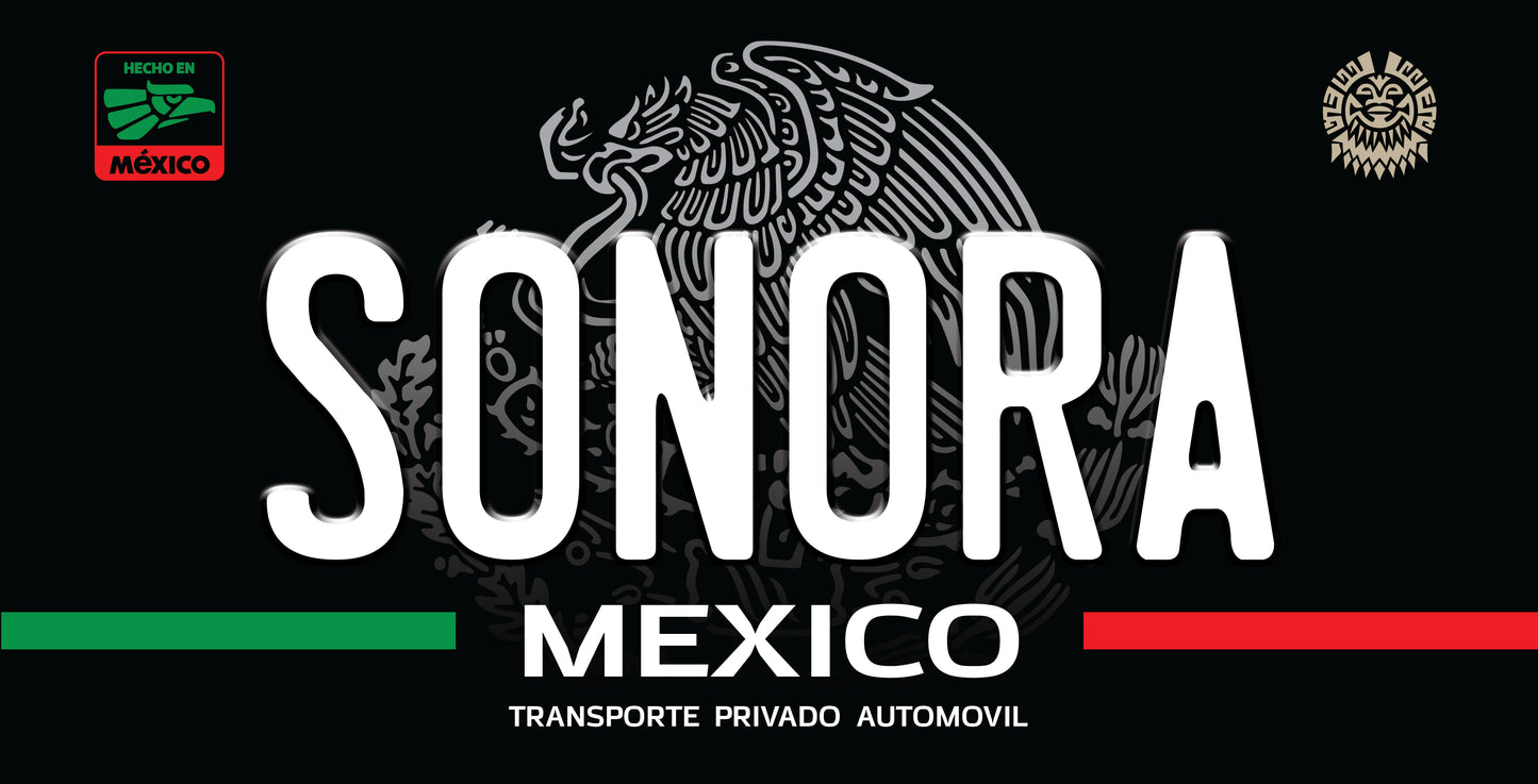 A black license plate style sign featuring the word 'SONORA' in large white letters, with 'MEXICO' and 'TRANSPORTE PRIVADO AUTOMOVIL' below. The design includes the Mexican flag colors as green and red stripes at the bottom and a grayscale eagle emblem in the background.