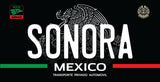 A black license plate style sign featuring the word 'SONORA' in large white letters, with 'MEXICO' and 'TRANSPORTE PRIVADO AUTOMOVIL' below. The design includes the Mexican flag colors as green and red stripes at the bottom and a grayscale eagle emblem in the background.