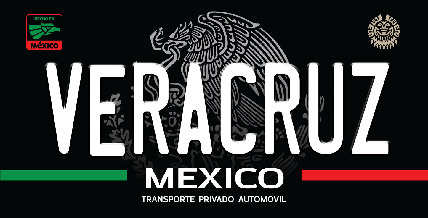 A black license plate style sign featuring the word 'VERACRUZ' in large white letters, 'MEXICO' below, and 'TRANSPORTE PRIVADO AUTOMOVIL' underneath. The design includes the Mexican coat of arms in gray, green and red horizontal bars, and two circular Mexican emblem marks at the top corners.